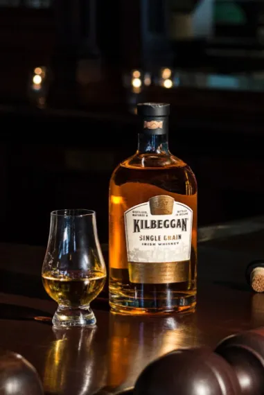 A bottle and a glass of Kilbeggan Irish whiskey
