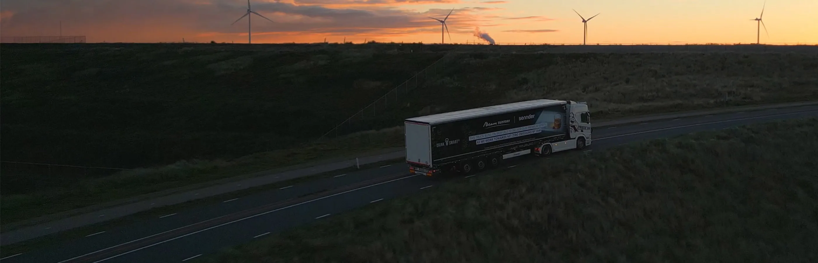 18 wheeler driving down highway into sunset